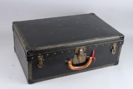 LOUIS VUITTON, A LARGE SUITCASE WITH BLACK LEATHERCLOTH COVERING, brass locks and black japanned