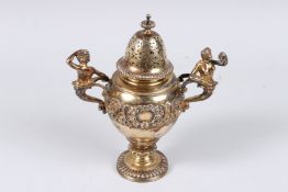 A GOOD SILVER GILT MINIATURE CHALLENGE CUP, the handles with classical figures. 7ins high. London