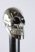 A WALKING STICK with a chrome skull.