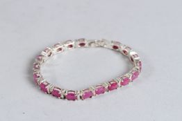 A SILVER AND RUBY TENNIS BRACELET.