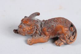 A CARVED WOOD FOO DOG.