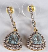 A PAIR OF DROP EARRINGS SET WITH TRILLIANT AQUAMARINES surrounded by a double halo of R/C diamonds
