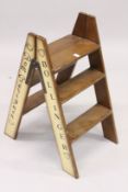A SET OF WOODEN CHAMPAGNE FOLDING STEPS. 2ft 9ins high.