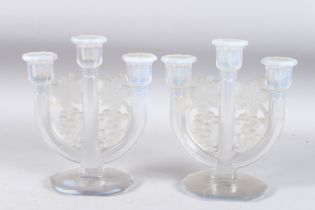 A PAIR OF BLUE TINTED THREE BRANCH CANDLESTICKS decorated with fruiting vines. 8.5ins high.