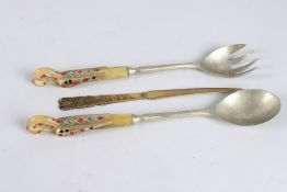 AN EGYPTIAN INLAID HORN SALAD SERVER AND LETTER OPENER.