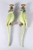 A PAIR OF GREEN PARROT PORCELAIN AND PARROT METAL WALL LIGHTS. 19ins high.
