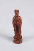 A CARVED WOOD GOD FIGURE. 4ins high.
