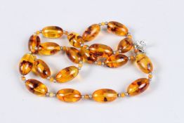 AN AMBER NECKLACE. 22ins long.