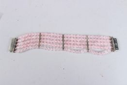 A SILVER GILT AND ROSE QUARTZ BRACELET.