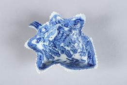 A WILLOW PATTERN BLUE AND WHITE LEAF DISH.