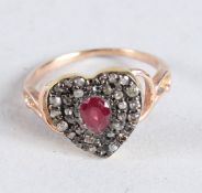 A GOLD DIAMOND AND RUBY HEART SHAPED RING.