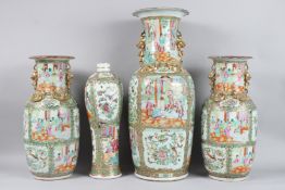 FOUR 19TH CENTURY CANTON VASES with panels of flowers and birds, comprising a large vase 24ins high.