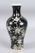 A CHINESE FAMILLE NOIR VASE with almond blossom and six-character mark. 11ins high.