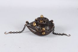 A GOOD CHINESE BRONZE CIRCULAR CENSER AND COVER with applied flowers and chain. 4ins.