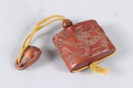 A JAPANESE CARVED WOOD INRO with a dragon.