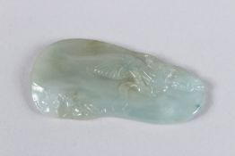 A CHINESE JADEITE PENDANT intricately carved depicting figures and scenery. 5cms long x 3cms wide.