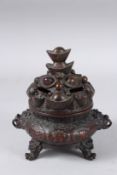 A SMALL CHINESE BRONZE CIRCULAR CENSER AND COVER with dragon lion ring handles. 7ins high.