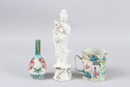 A CANTON MUG 4.25ins, a small Imari bottle vase 5.5ins and a blanc-de-chine figure of Quan Yin 10ins