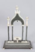 A VERY GOOD INDIAN SADDLE WORK WATCH STAND, with column supports on a rectangular base. 11ins high.