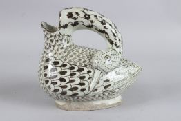 AN UNUSUAL 19TH CENTURY PERSIAN QAJAR SIGNED GLAZED POTTERY DUCK SHAPED JUG. 8.5ins high.
