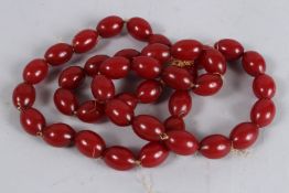 A CHERRY AMBER BEAD NECKLACE.