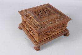 A VERY FINE 19TH CENTURY INDIAN MAYSORE CARVED SANDALWOOD BOX with jungle scenes. 8ins square.
