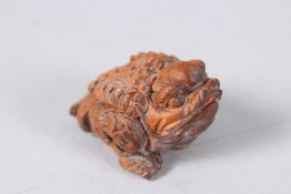 A CARVED WOOD TOAD. 2ins.