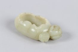 A CHINESE HETIAN JADE BRUSH POT on a lily with two flower buds. 9cms long x 4.5cms wide x 2.5cms