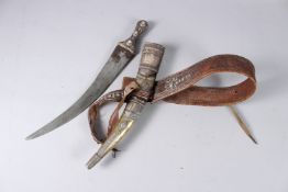 A FINE 19TH CENTURY ARAB SAUDI WAHABI HORN HILTED SILVER MOUNTED DAGGER with its original belt.