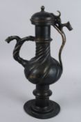 A LARGE ISLAMIC, OR POSSIBLY EUROPEAN, BRASS / BRONZE EWER with zoomorphic handle. 17ins high.