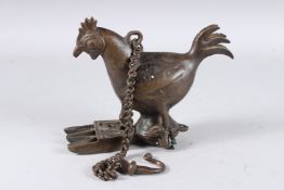 A 19TH CENTURY INDIAN BRONZE CHICKEN SHAPED OIL LAMP. 20cms wide.