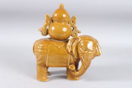 A CHINESE BROWN GLAZED ELEPHANT. 10ins high.