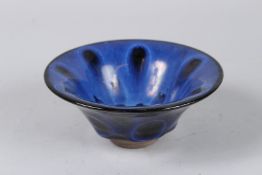 A CHINESE BLUE STONEWARE CIRCULAR BOWL. 5ins diameter.