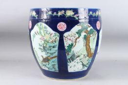 A LARGE CHINESE BLUE GROUND JARDINIERE with panels of birds. 14.5ins diameter x 14ins high (AF).