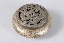 A CHINESE WHITE METAL CIRCULAR CENSER AND COVER. 4ins diameter.