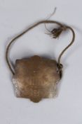 A FINE 19TH CENTURY PERSIAN QAJAR ENGRAVED BRASS TALISMANIC ARM BAND AMULET. 3ins.