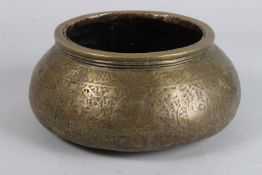 A 19TH CENTURY PERSIAN QAJAR BRASS HANDLED CARVED BOWL. 9ins diameter.