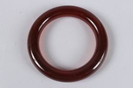 A PLAIN AMBER BRACELET. 8cms. 52grams.