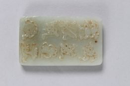 A CHINESE HETIAN JADE PENDANT carved with eight motifs in relief. 6cms long x 3.5cms wide. 74grams.