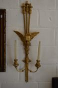 A pair of carved gilt wood twin branch wall appliques with classical eagle mounts.