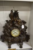 A large cast metal mantel clock.