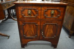 A Regency mahogany small side cabinet or sideboard with a single deep drawer above a pair of
