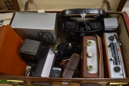 A suitcase containing old radios, binoculars etc.