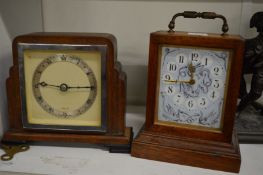 Two small mantel clocks.