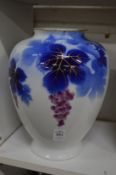 A Japanese Fukagawa porcelain vase decorated with fruiting vine.
