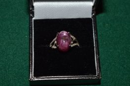 A silver ring set with a 9ct star ruby, with certificate.