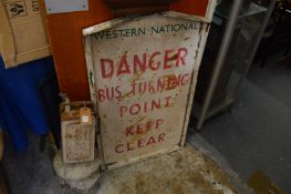 An old metal bus sign and a Valor petrol can.