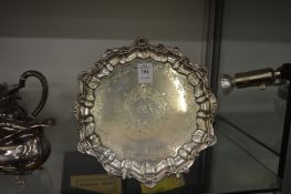 A silver waiter with shell cast border and engraved decoration.