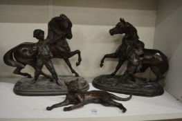 A pair of spelter Marley horses and a small cast model of a cat.