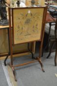 Mahogany fire screen with floral embroidered panel.